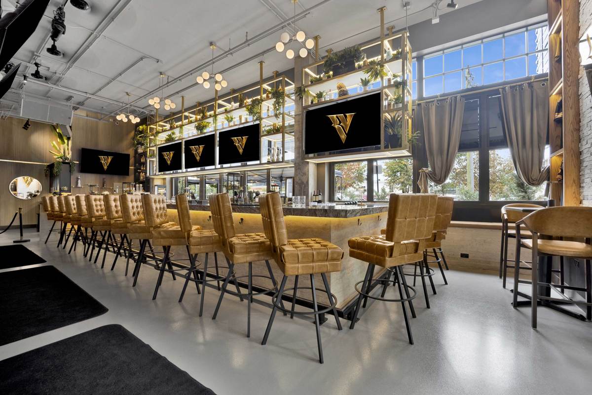 Quilted gold bar stools facing the screens and the front windows in daylight.