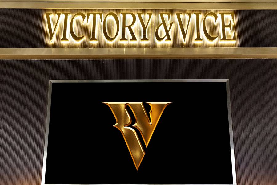 The lit Victory & Vice sign above the gold V on the screen.