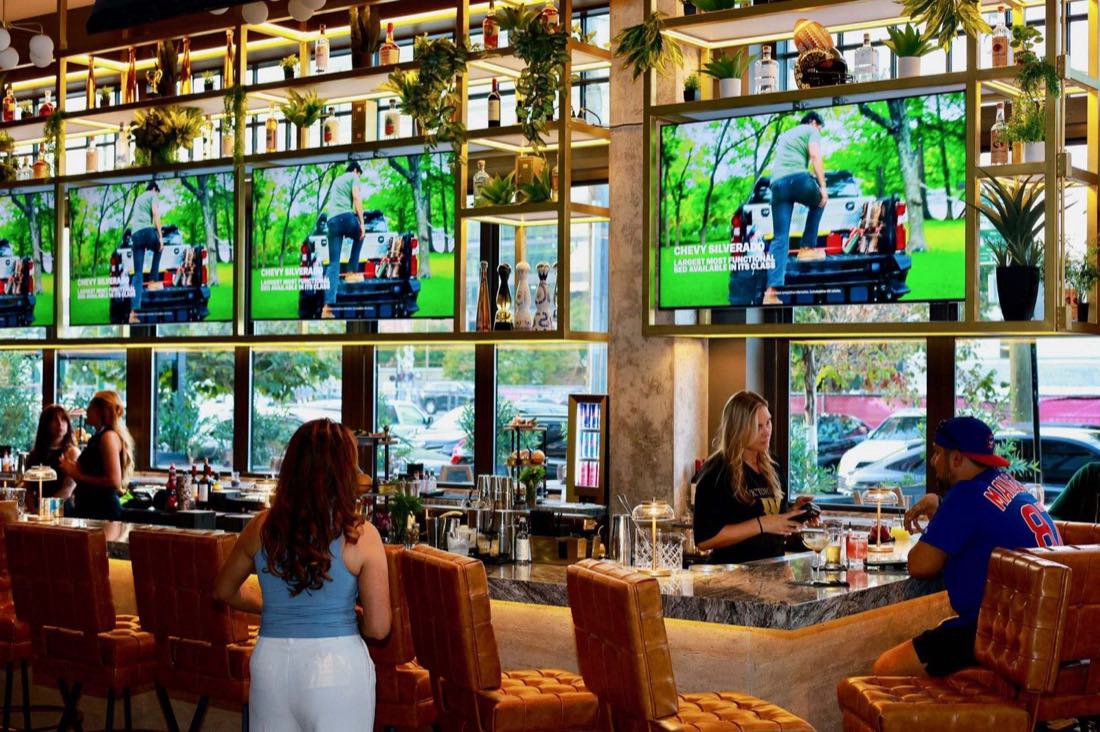 The bar under a wall of screens, every one of them showing the game.