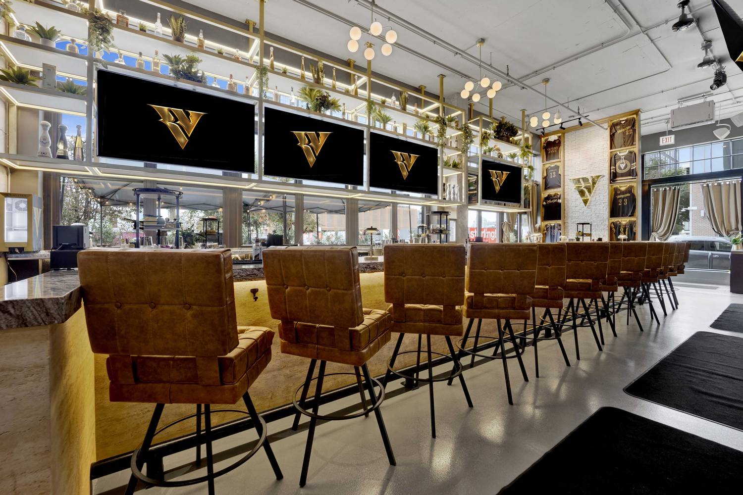 The bar in daylight, quilted stools along the rail and the back bar lit under the screens.