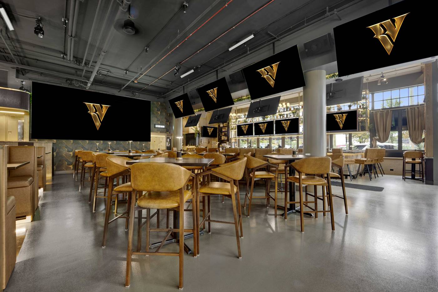 The room set before doors, leather high-tops facing the seventeen-foot LED and the screens above the bar.
